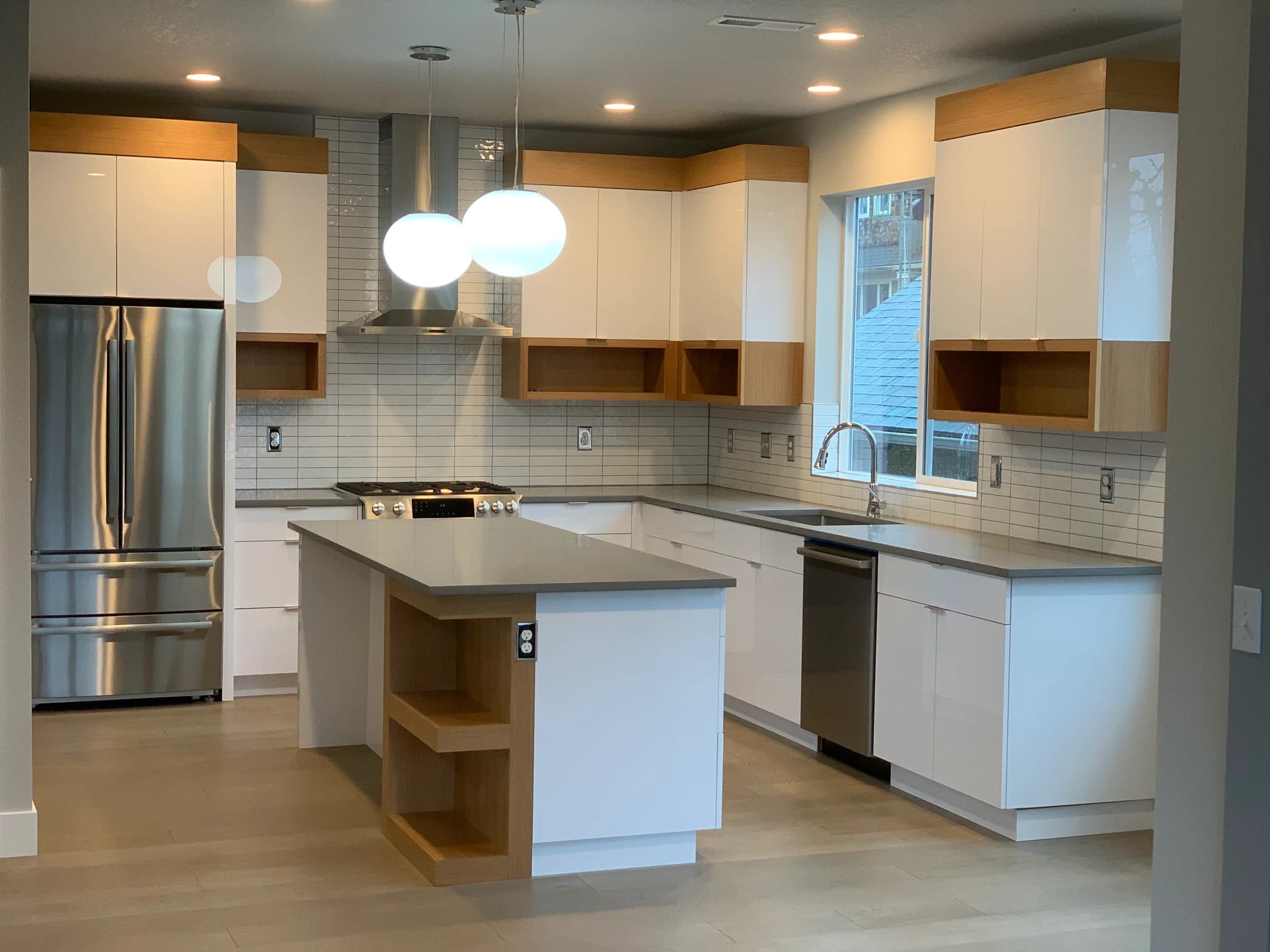 NS Wood Finishing project: white flat-panel kitchen cabinets with wood trim and a wood-accented island
